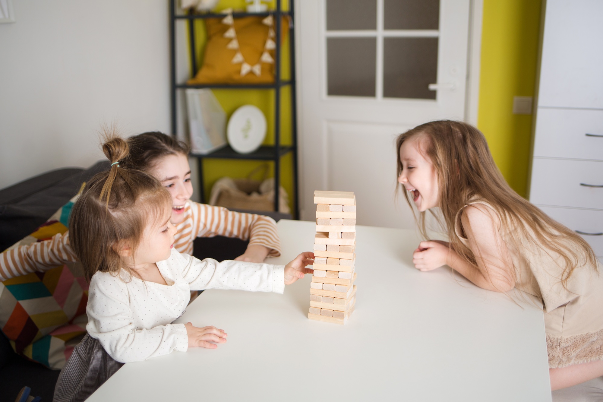 children play board game jenga.