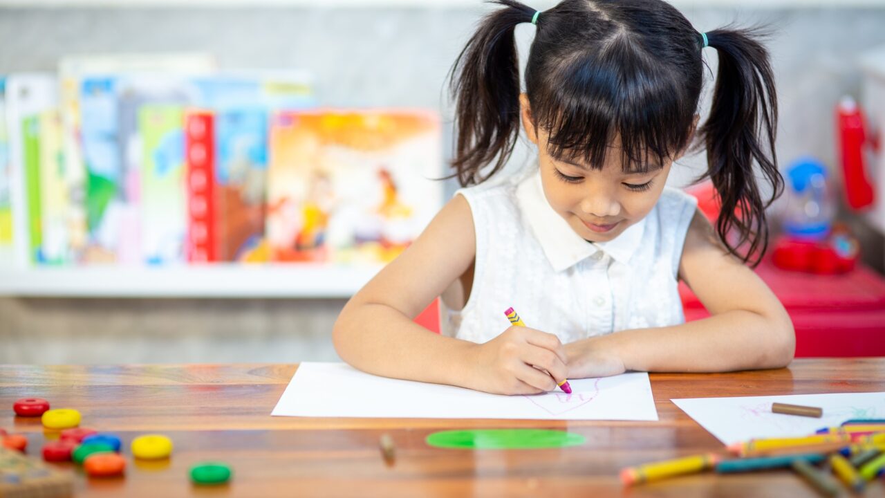 Preschooler child girl drawing and coloring