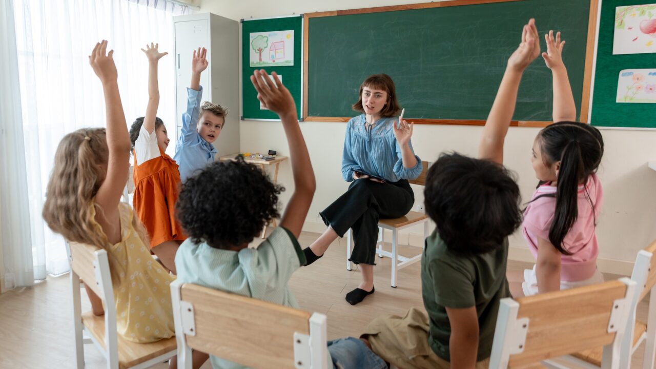 Caucasian young woman teacher teaching student in classroom at school.