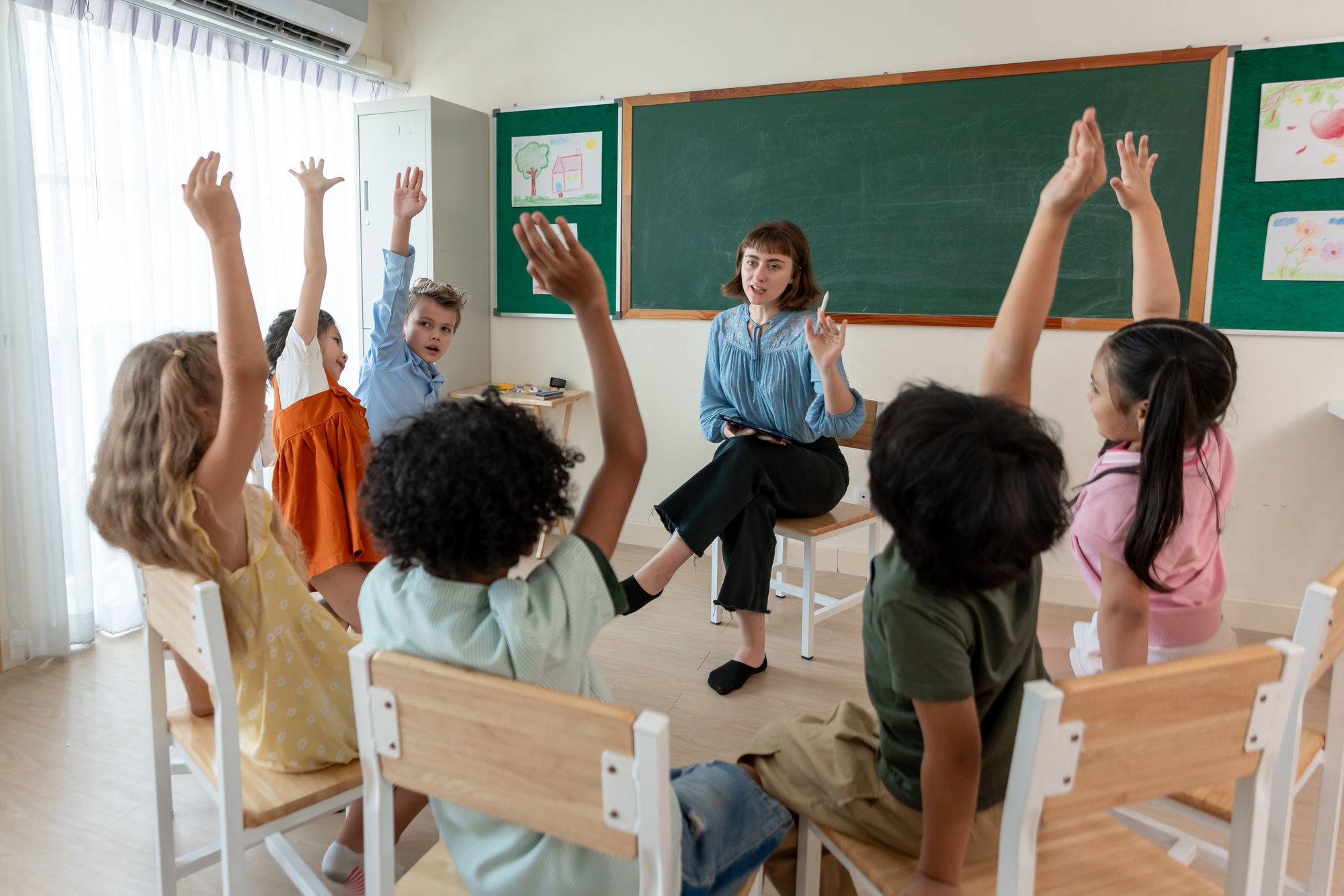 Caucasian young woman teacher teaching student in classroom at school.