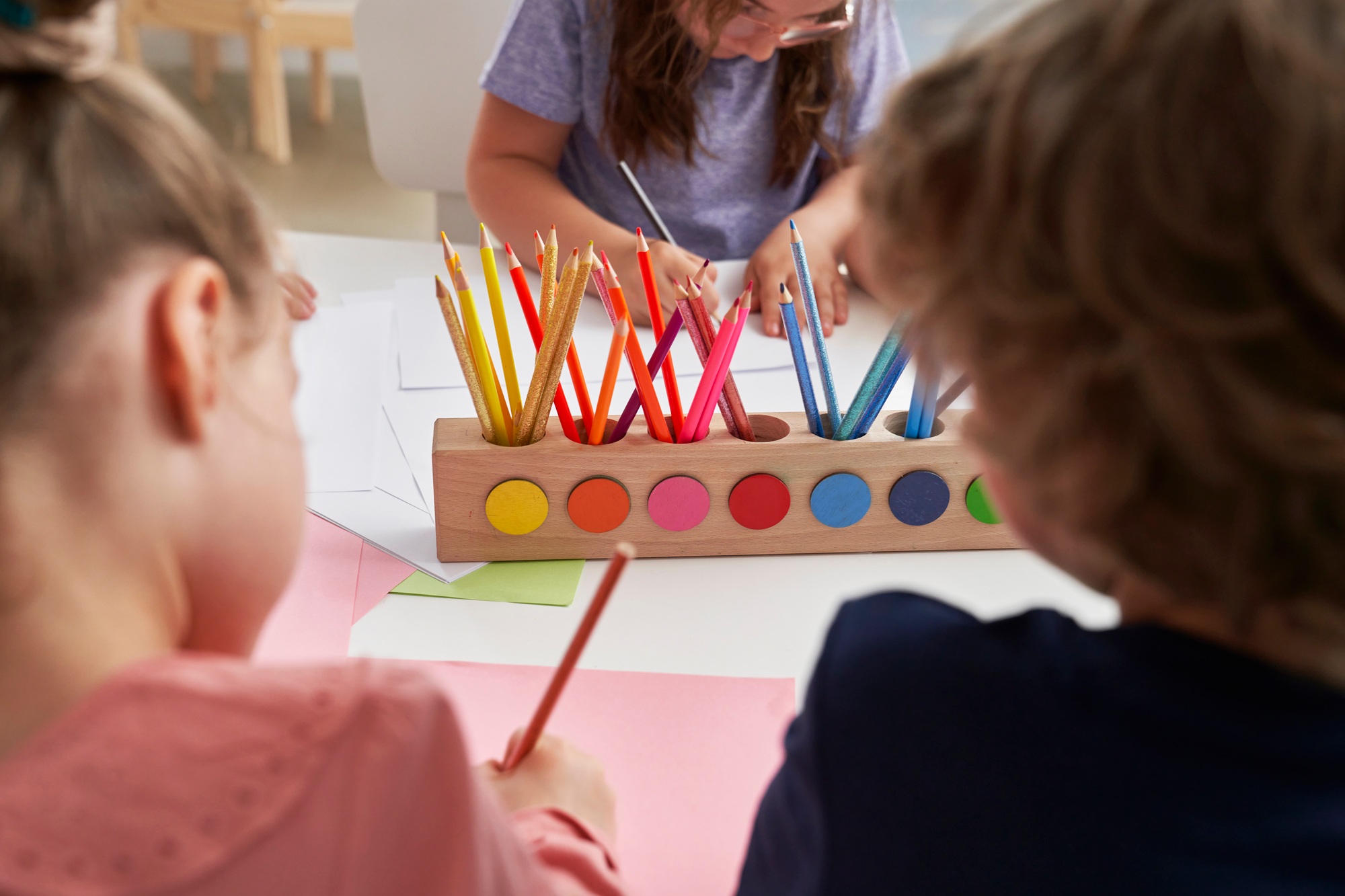 Colorful pencils and children drawing around