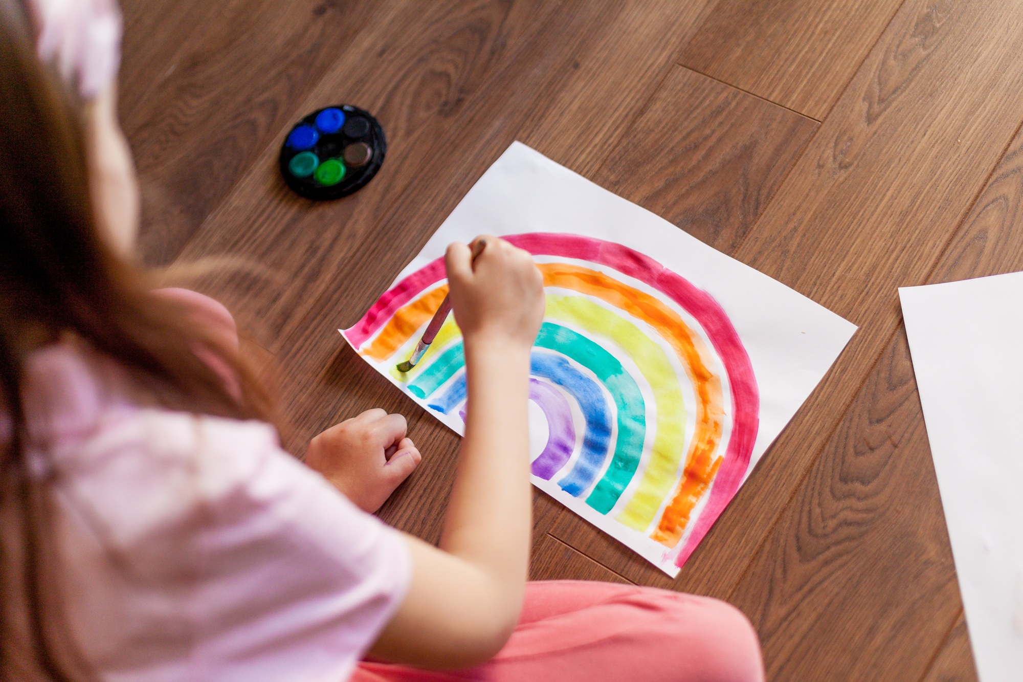 Girl drawing a rainbow