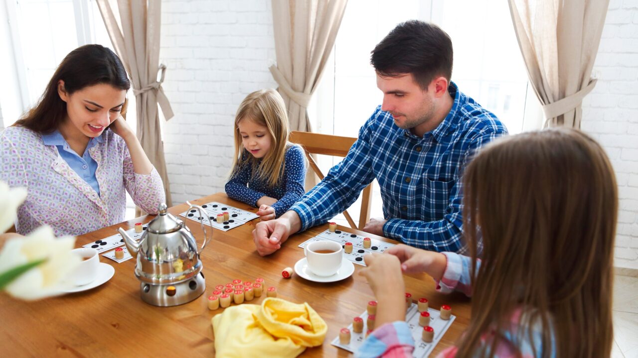Happy young family plaing board game