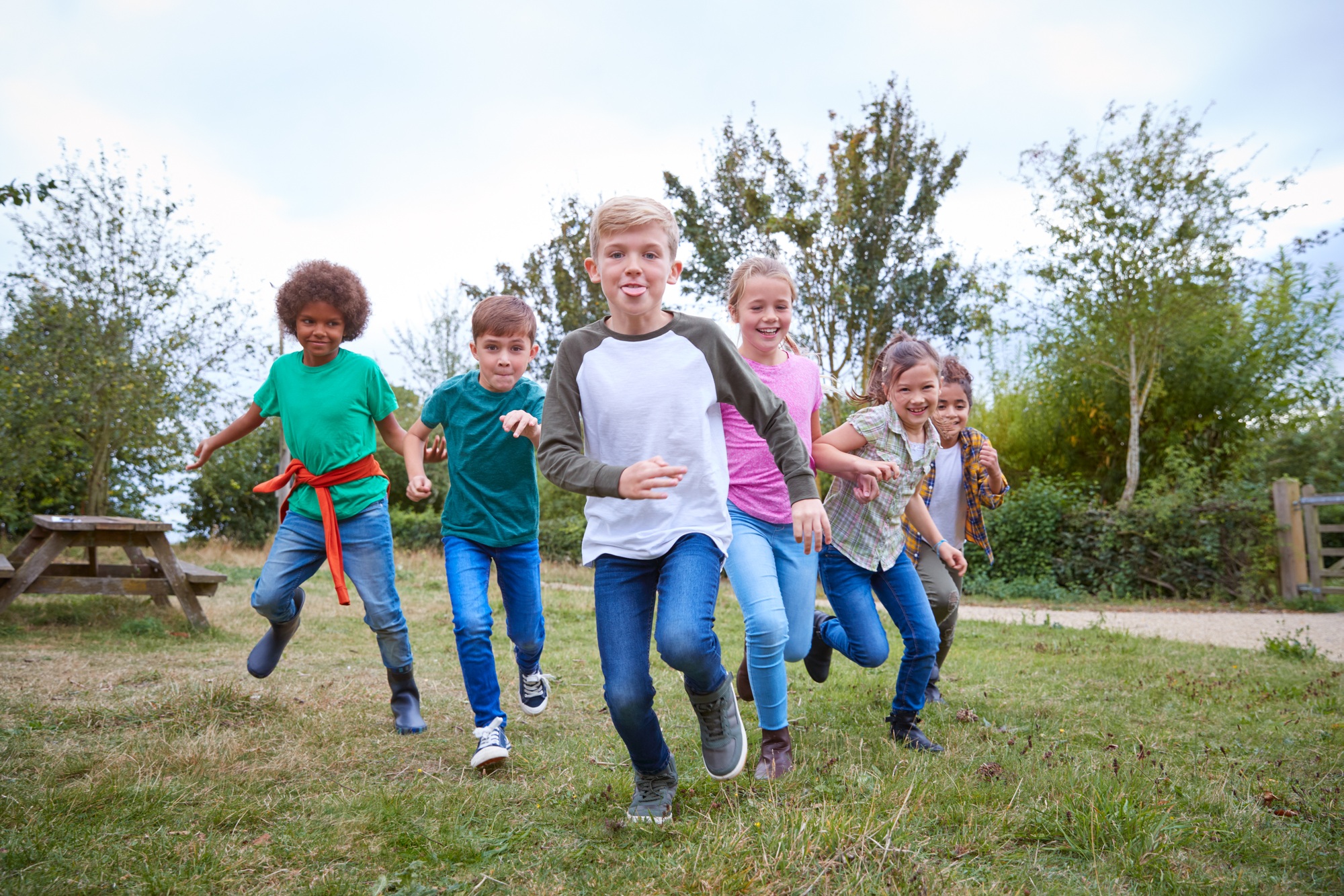 Portrait Of Children On Outdoor Activity Camping Trip Having Fun Playing Game Together