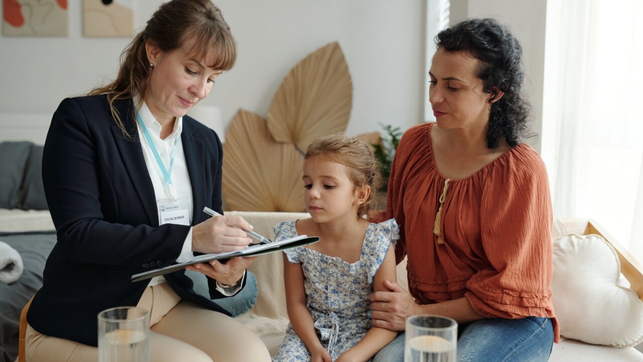 Social Worker Visiting To Adoptive Family At Home