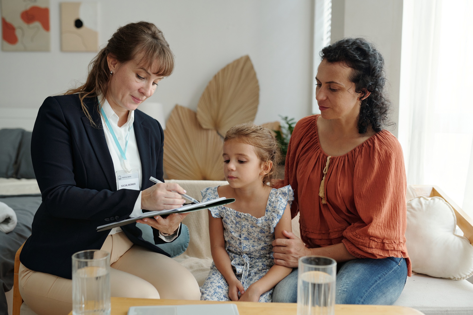 Social Worker Visiting To Adoptive Family At Home