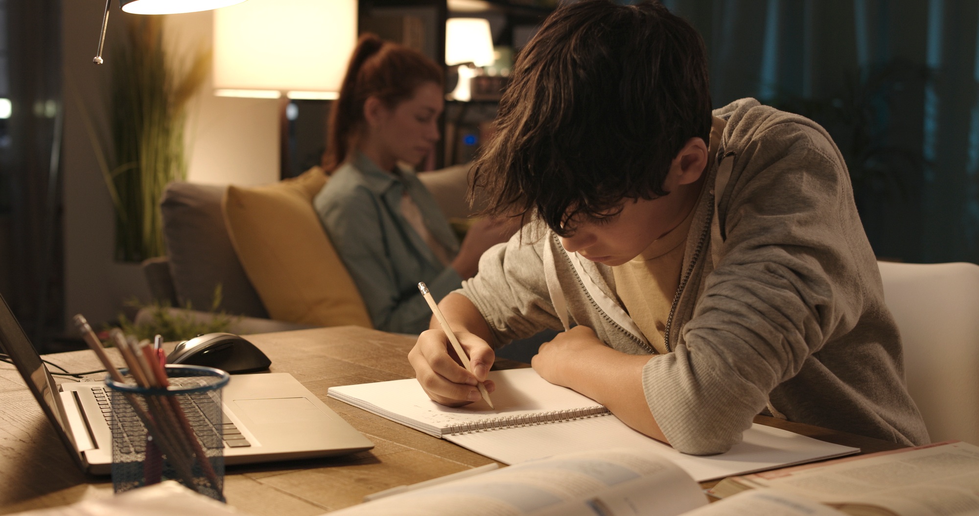 Student doing his homework at home