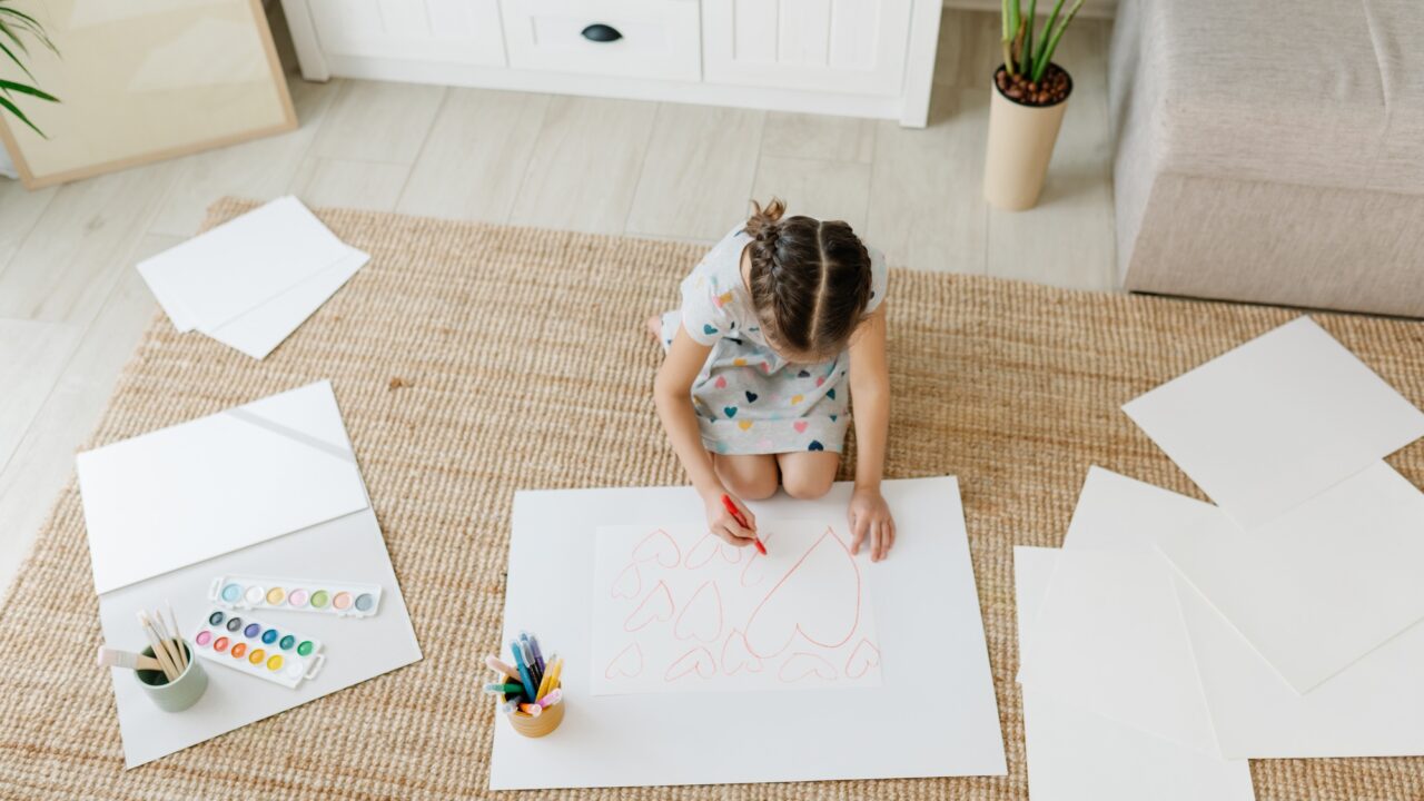 Child drawing hearts