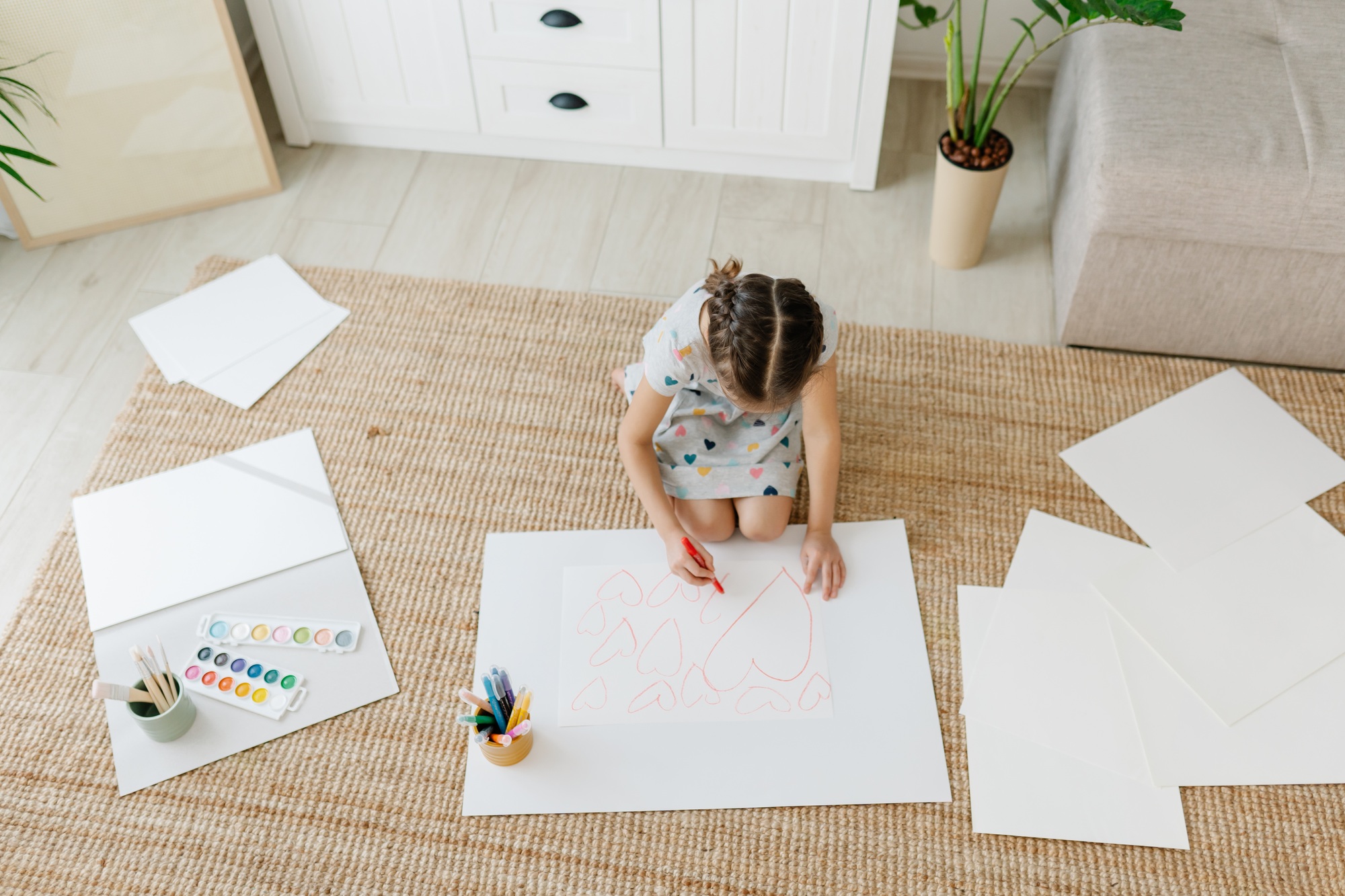 Child drawing hearts