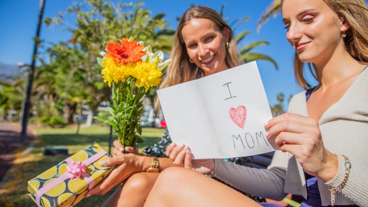 Daughter reads written dedication to mother on Mother's Day, with the gifts and flowers she gave her