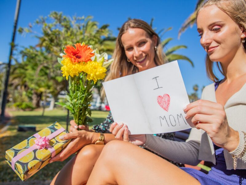Daughter reads written dedication to mother on Mother's Day, with the gifts and flowers she gave her