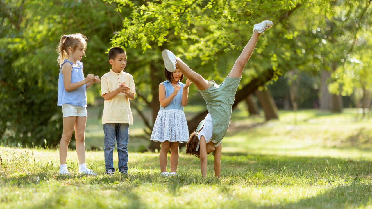 Group of asian and caucasian kids having fun in the park