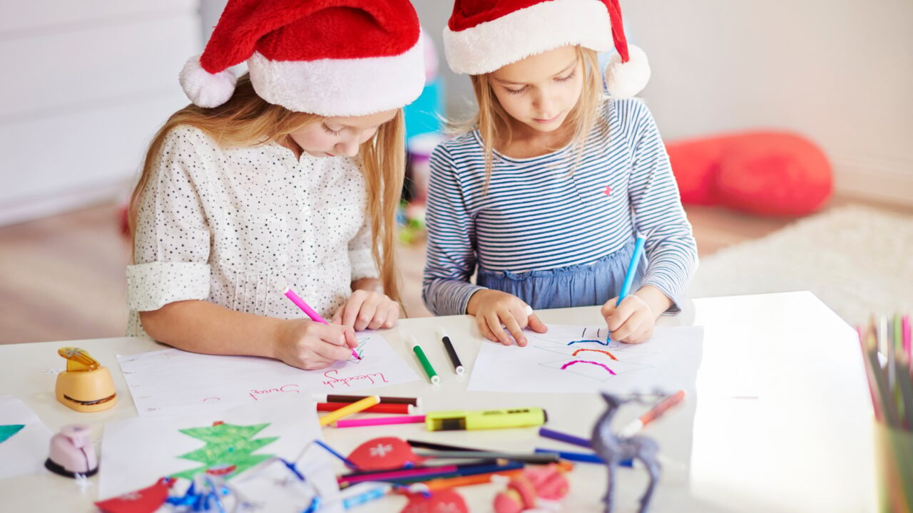 Pensive girls drawing christmas paintings
