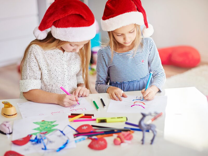 Pensive girls drawing christmas paintings